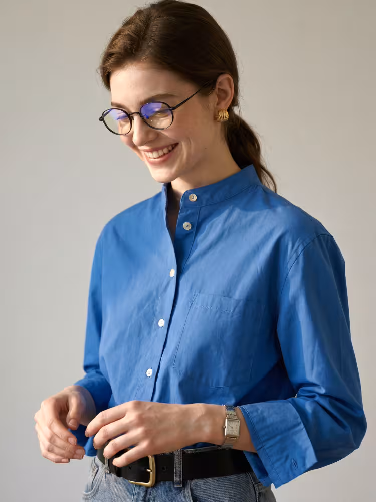 Female model wearing vintage black oval titanium eyeglasses in a bright studio setting. SPU: OT0282502