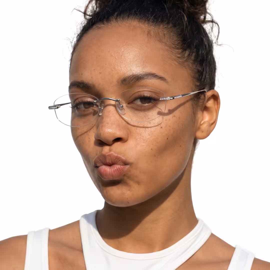Front view of female wearing fashion silver oval eyeglasses, pouting, OT0312604