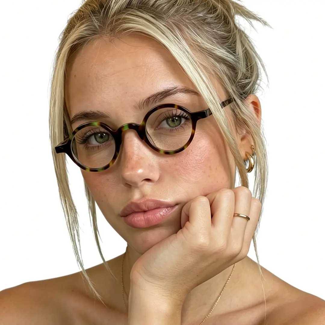 Female wearing vintage tortoise round acetate eyeglasses, natural expression while resting chin on hand. SPU: RA0012306