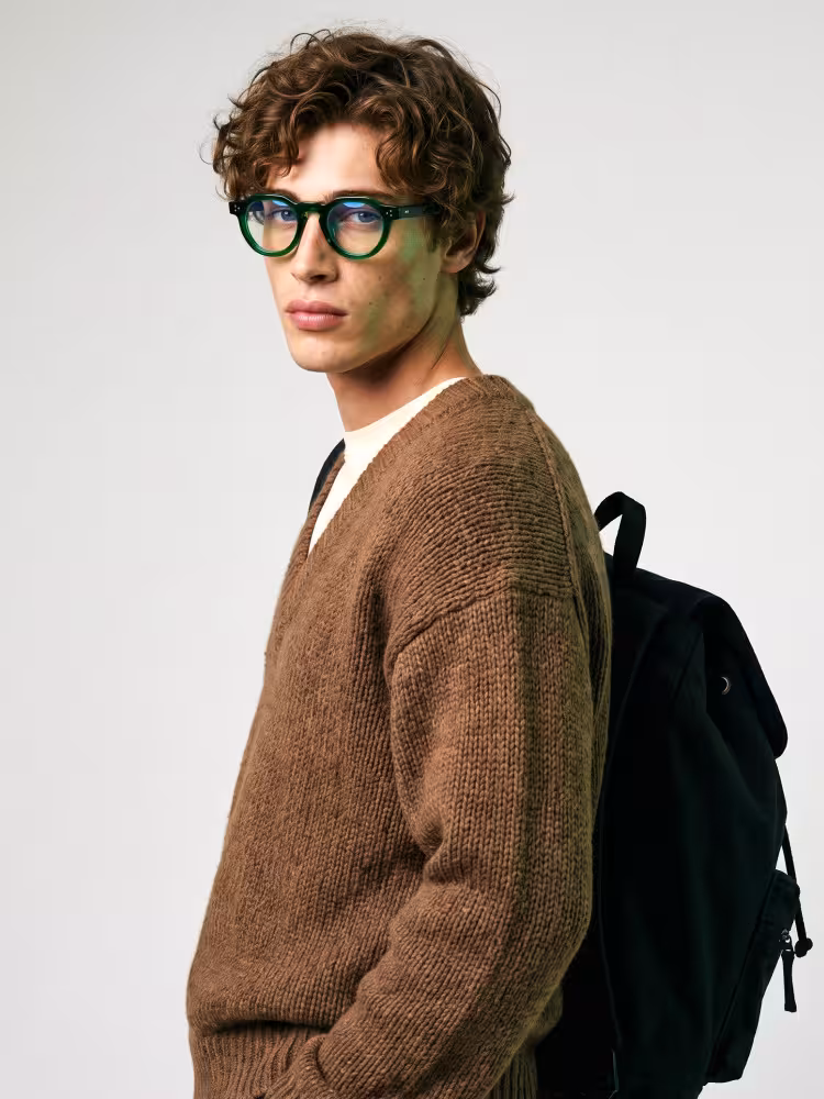 Male model wearing vintage green round acetate eyeglasses in studio setting. SPU: RA0012412