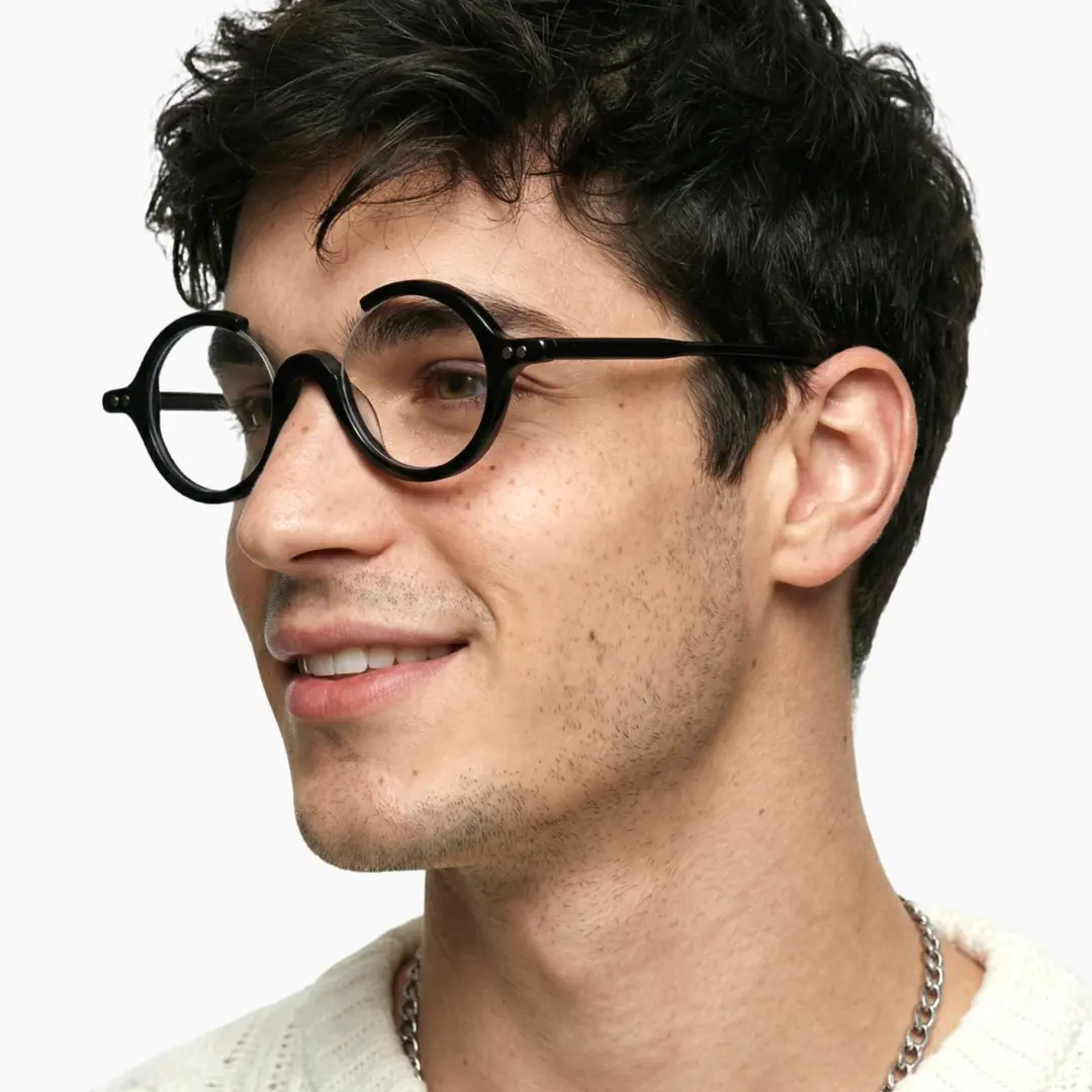 Looking away view of male wearing black round eyeglasses, natural smile, RA0022212