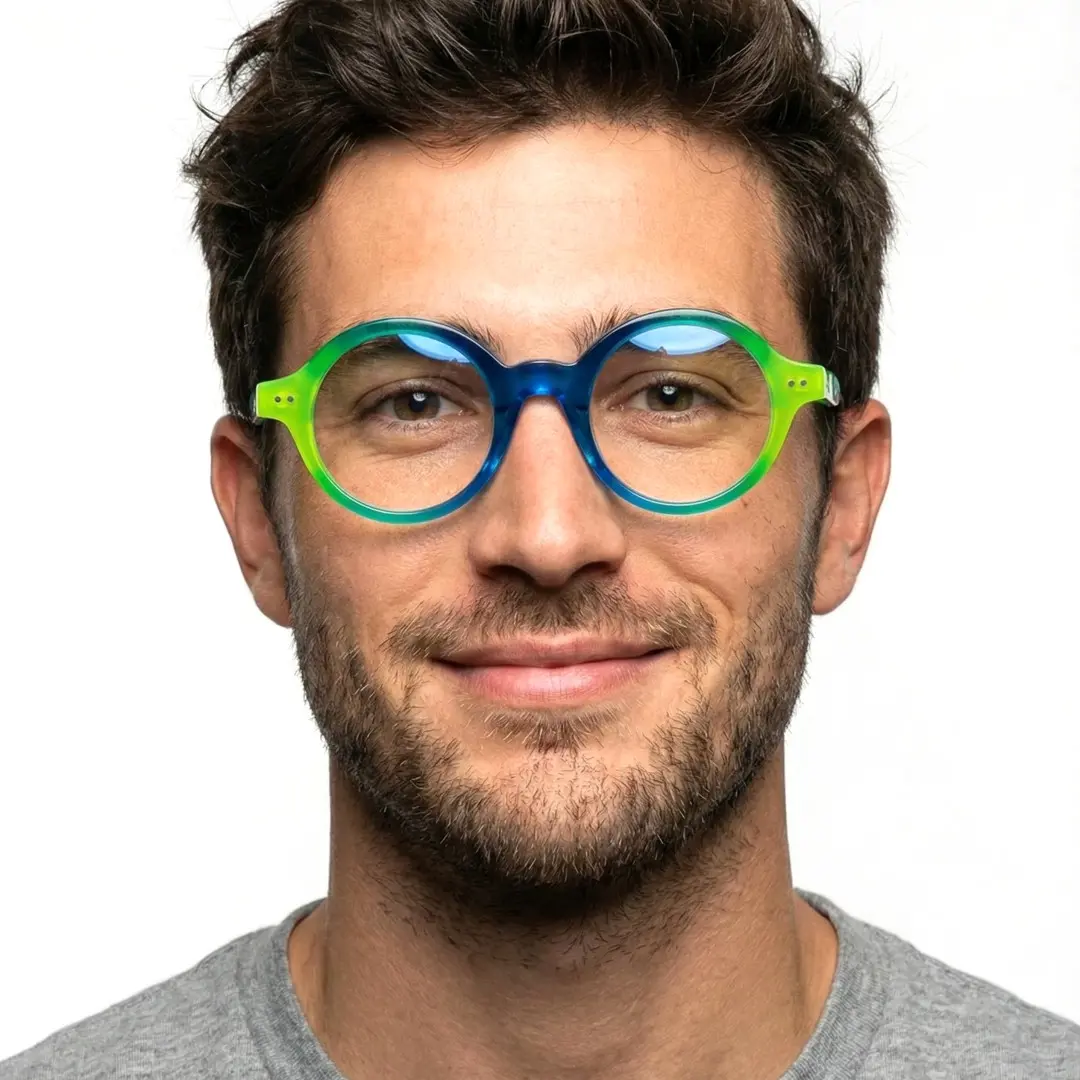 Front view of male wearing blue round eyeglasses, soft smile, RA0022307