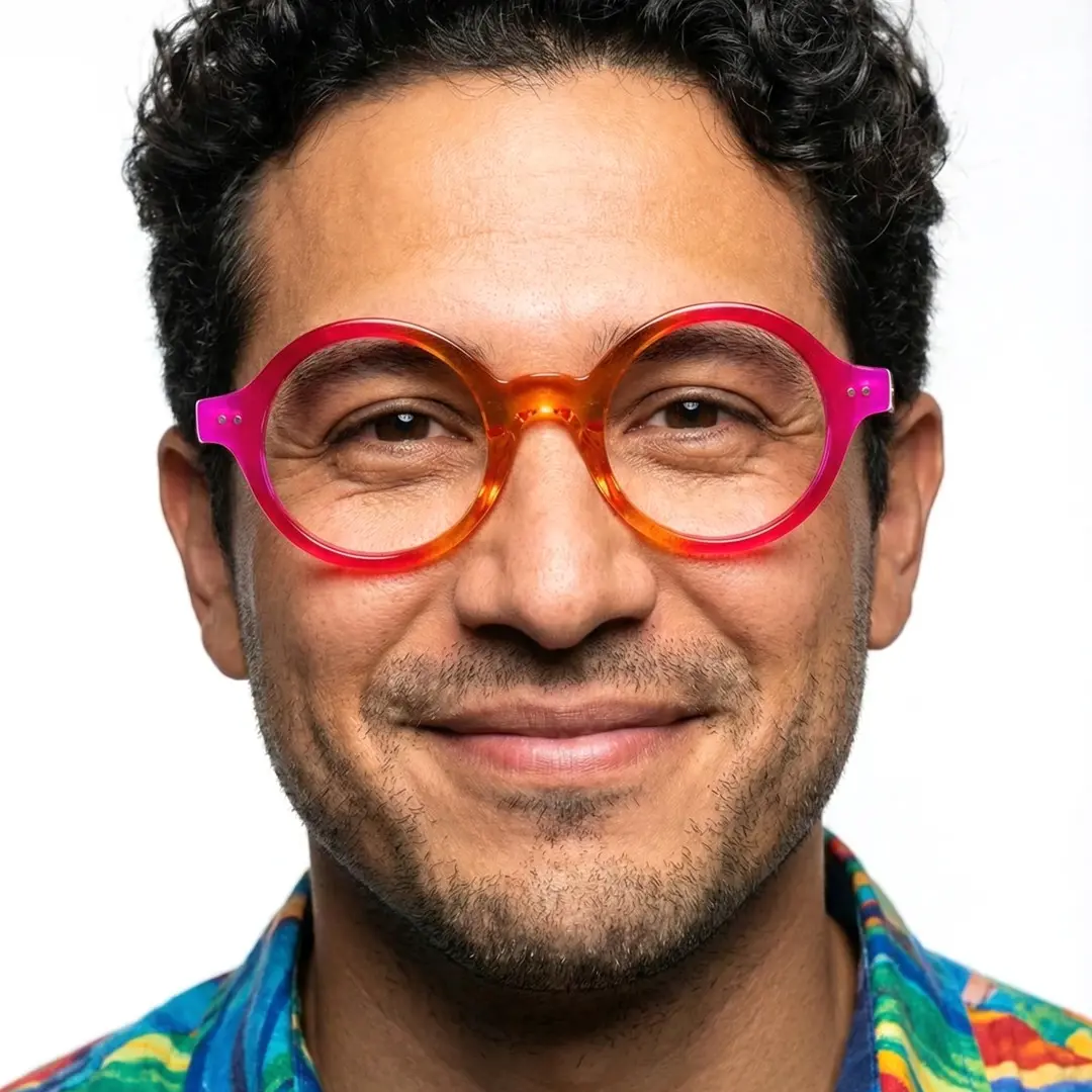 Front view of male wearing colorful orange round eyeglasses, friendly smile, RA0022307