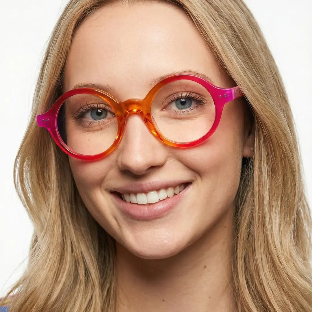 Three-quarter view of female wearing orange round eyeglasses, friendly smile, RA0022307