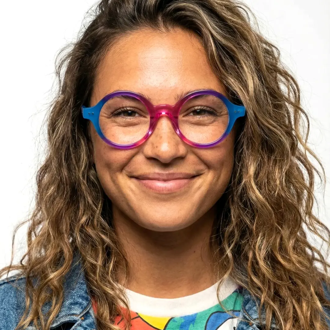 Front view of female wearing pink round eyeglasses, wide smile, RA0022307