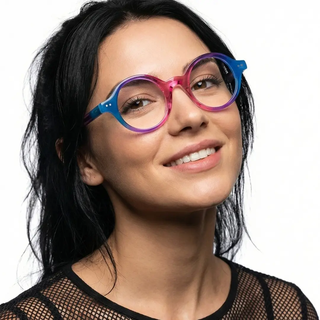 Profile view of female wearing pink round eyeglasses, tilting head, friendly smile, RA0022307