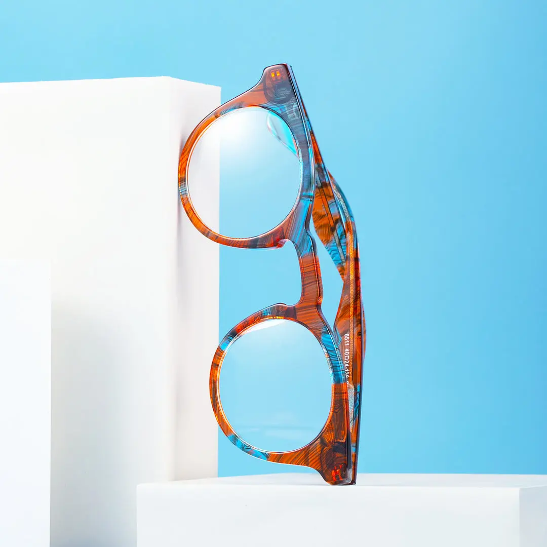 Scene close-up view of Esta colorful round acetate eyeglasses RA0032303 in orange