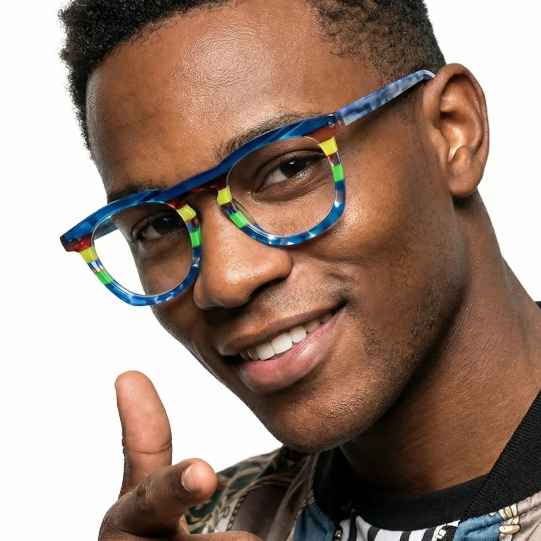 Three-quarter view of male wearing colorful blue round eyeglasses, smiling, RA0032407