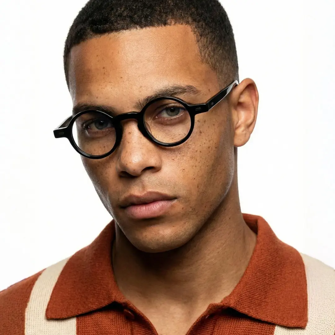 Front view of male wearing vintage black round eyeglasses, neutral expression, RA0042301