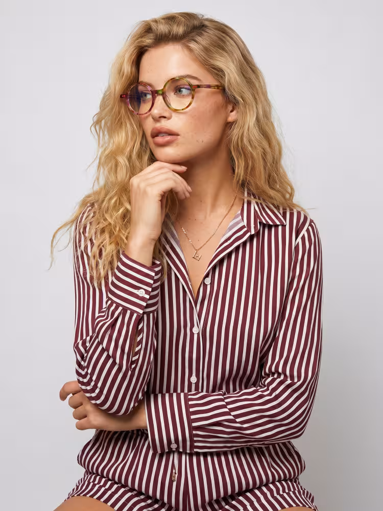 Female model wearing colorful tortoise round acetate eyeglasses in a studio setting. SPU: RA0052207