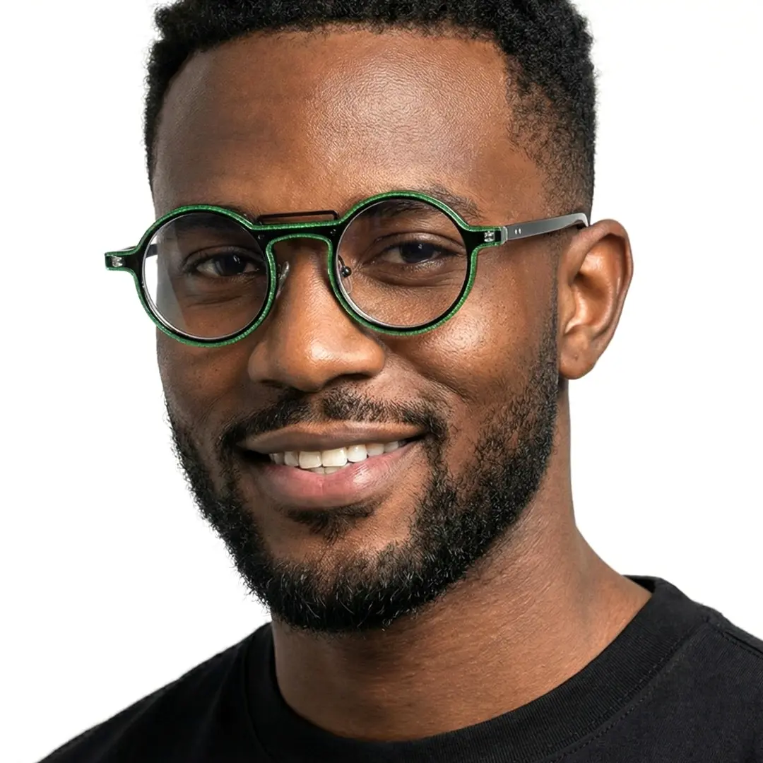 Front view of male wearing steampunk green round eyeglasses, soft smile, RA0052306