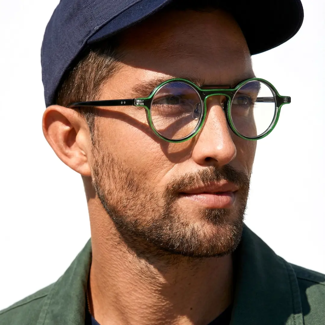 Three-quarter view of male wearing steampunk green round eyeglasses, relaxed expression, RA0052306