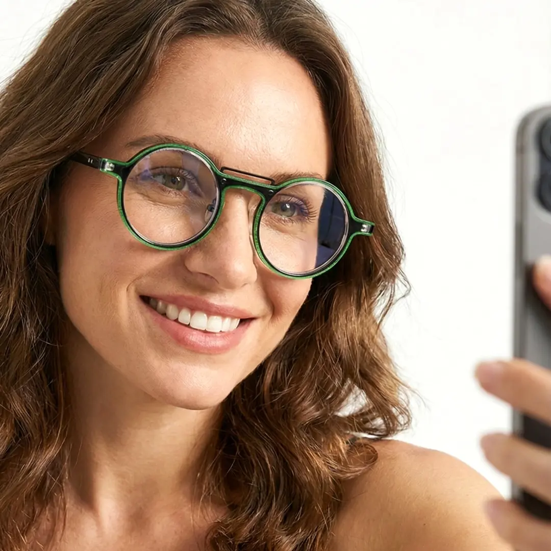 Front view of female wearing steampunk green round eyeglasses, smiling, RA0052306