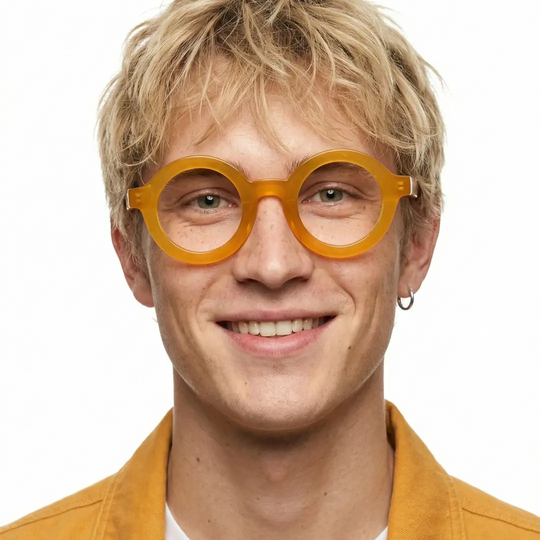 Front view of male wearing yellow round eyeglasses, smiling, RA0052408