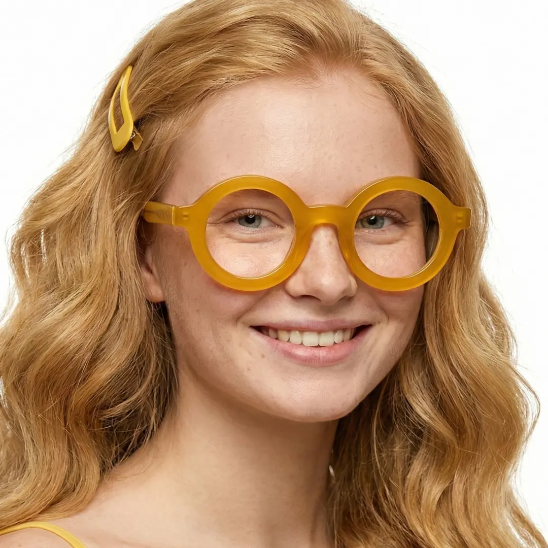 Three-quarter view of female wearing yellow round eyeglasses, smiling, RA0052408