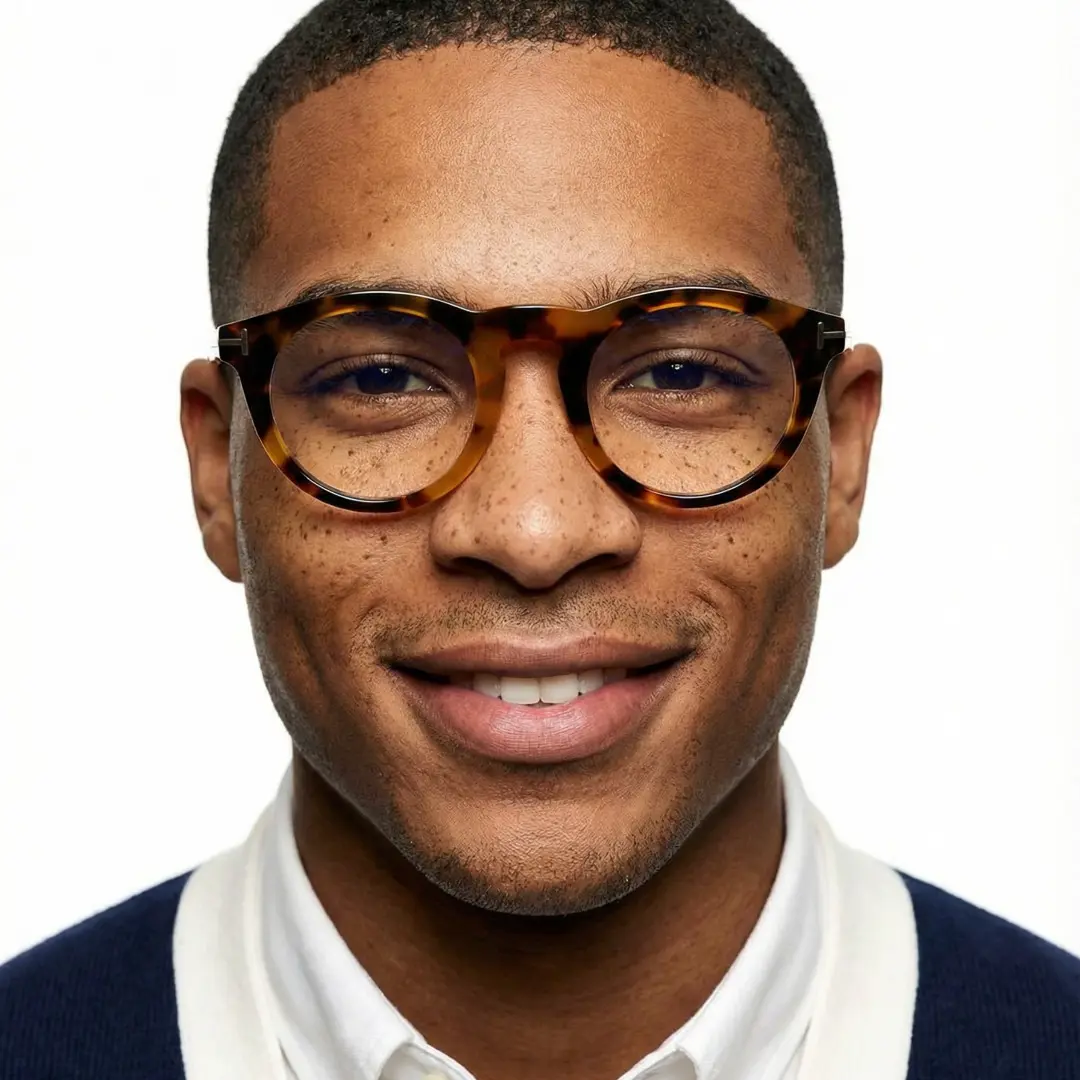 Front view of male wearing tortoise round eyeglasses, natural smile, RA0062506