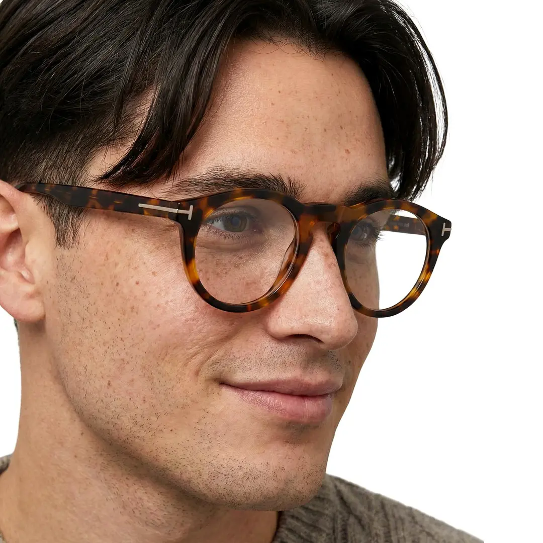 Looking away view of male wearing tortoise round eyeglasses, smiling, RA0062506