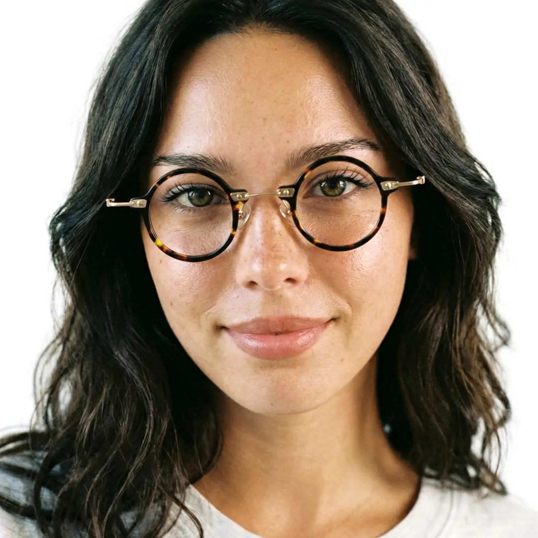 Front view of female wearing steampunk tortoise round eyeglasses, smiling, RA0092309
