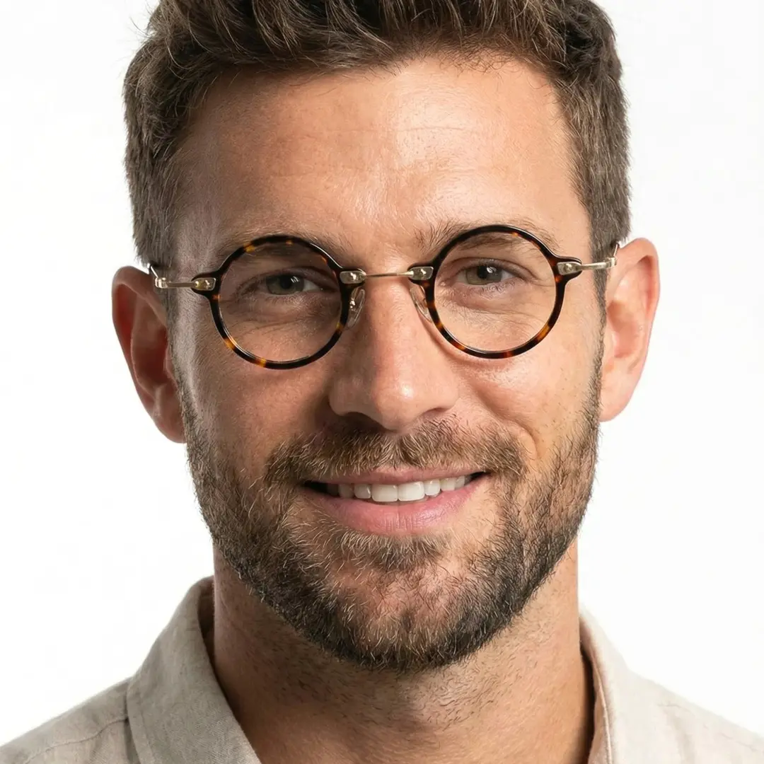 Front view of male wearing tortoise round eyeglasses, natural smile, RA0092309