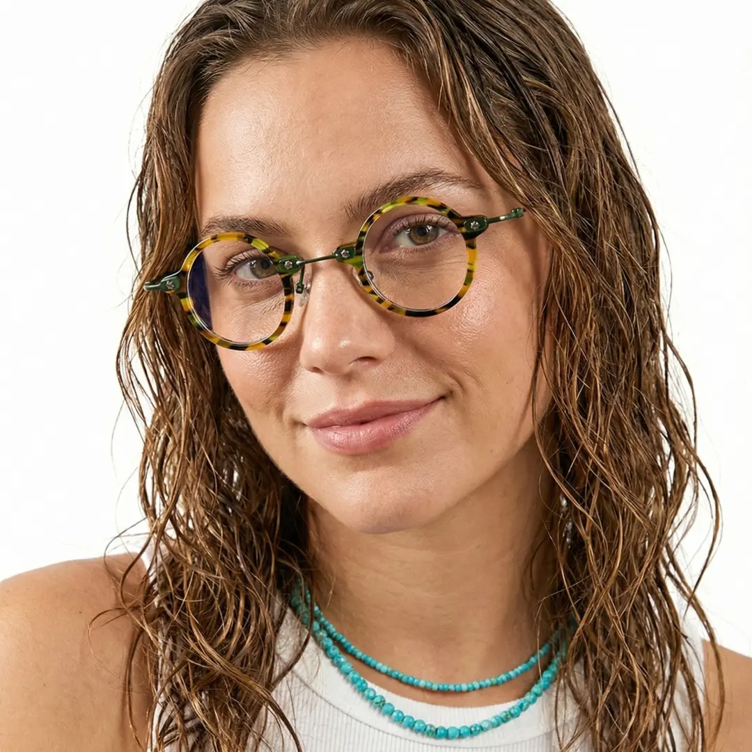 Front view of female wearing yellow tortoise round eyeglasses, smiling, RA0092309