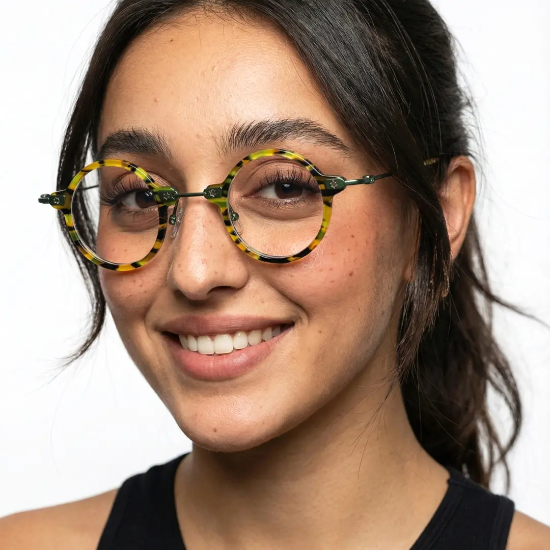 Three-quarter view of female wearing yellow tortoise round eyeglasses, natural smile, RA0092309