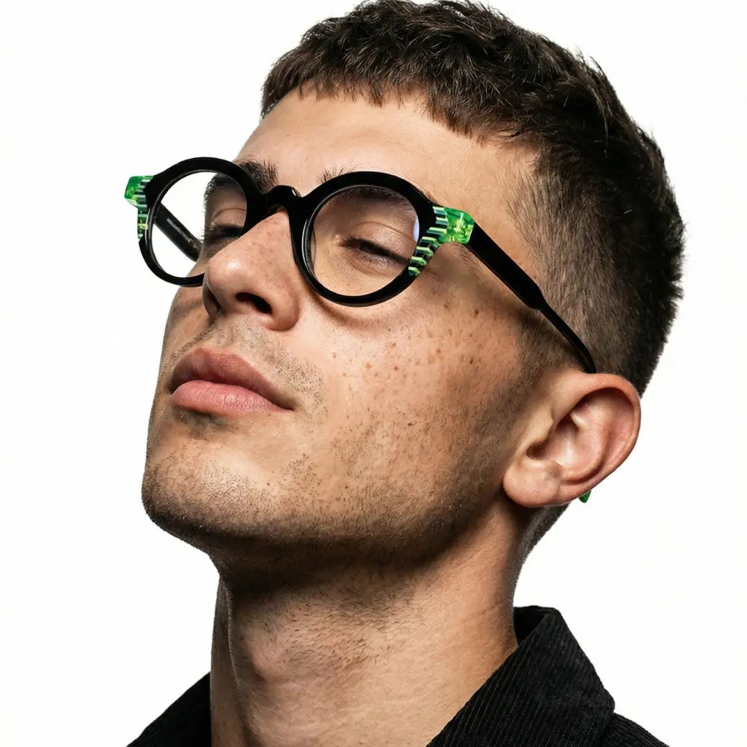 Looking away view of male wearing black round eyeglasses, natural expression, RA0102312