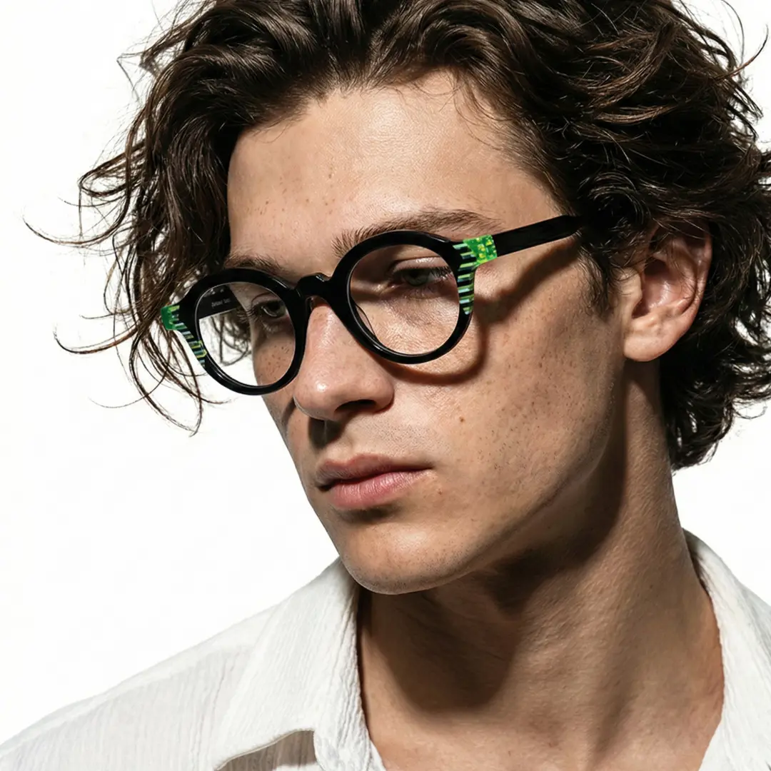 Profile view of male wearing black round eyeglasses, neutral expression, RA0102312