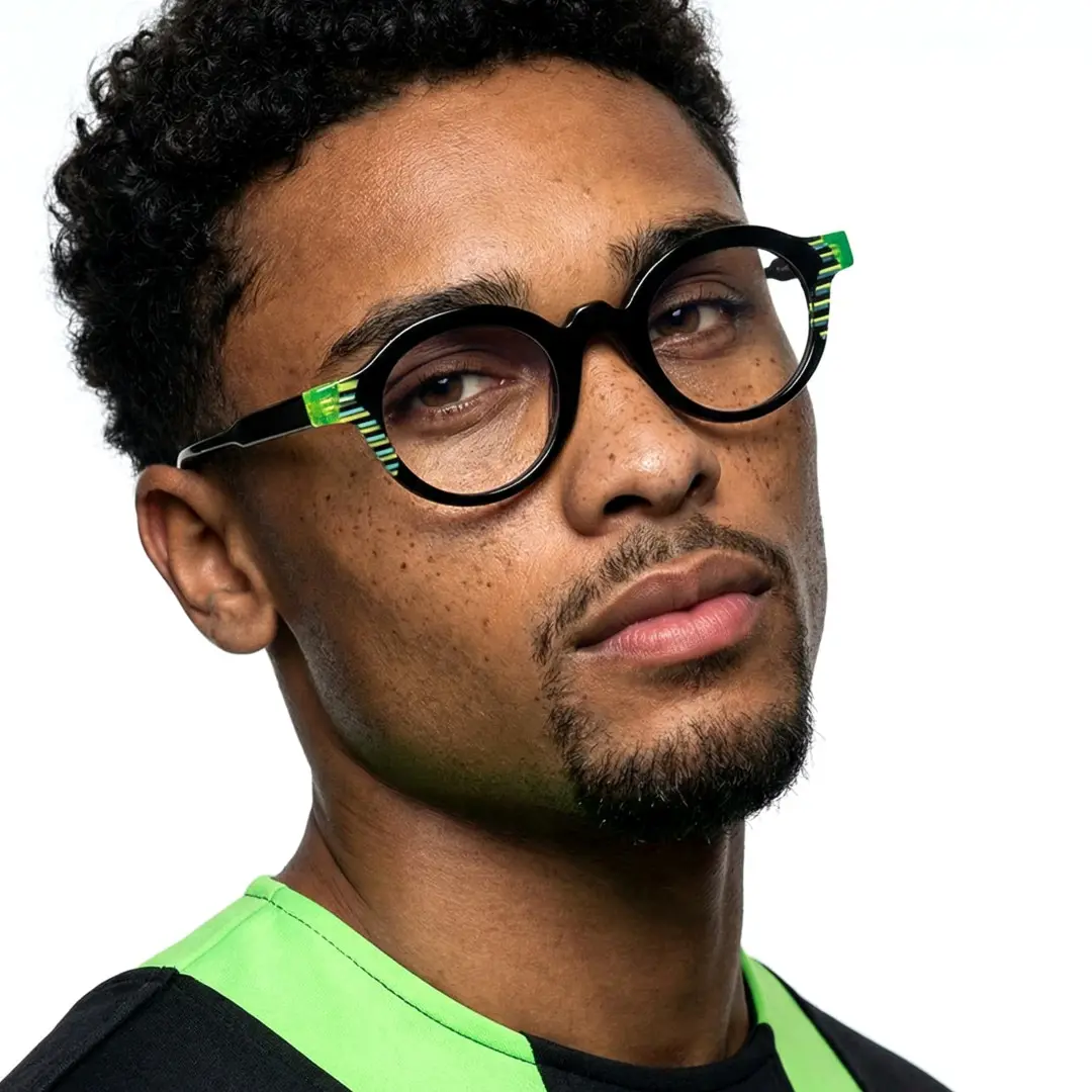 Three-quarter view of male wearing black round eyeglasses, natural expression, RA0102312