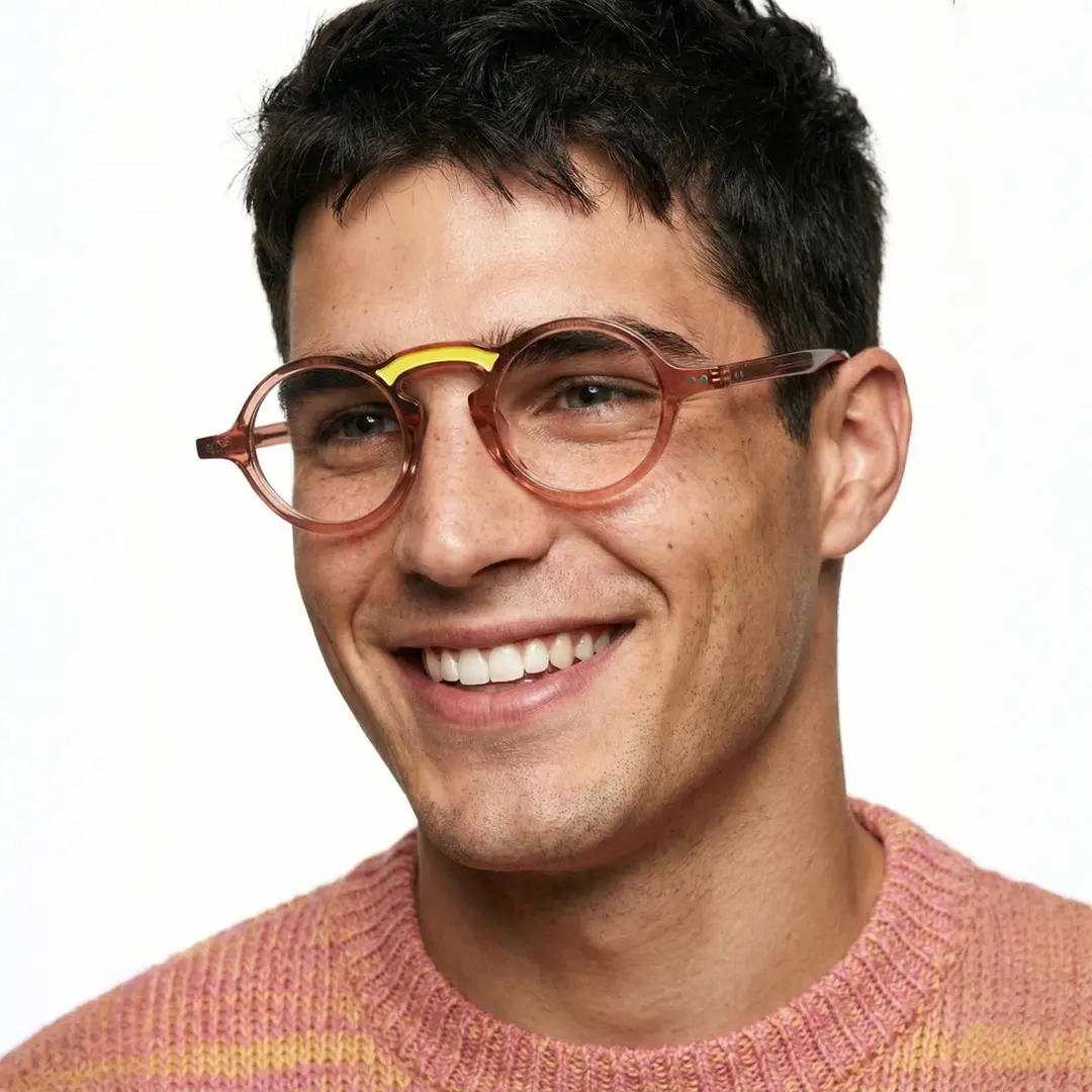 Three-quarter view of male wearing vintage brown round eyeglasses, smiling, RA0142306