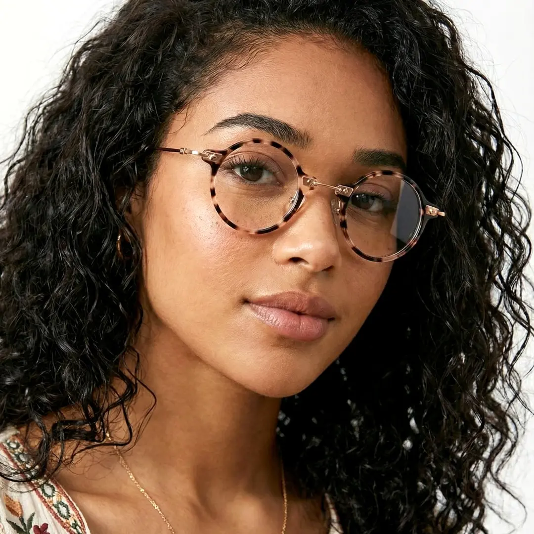 Three-quarter view of female wearing steampunk tortoise round eyeglasses, neutral expression, RA0142402