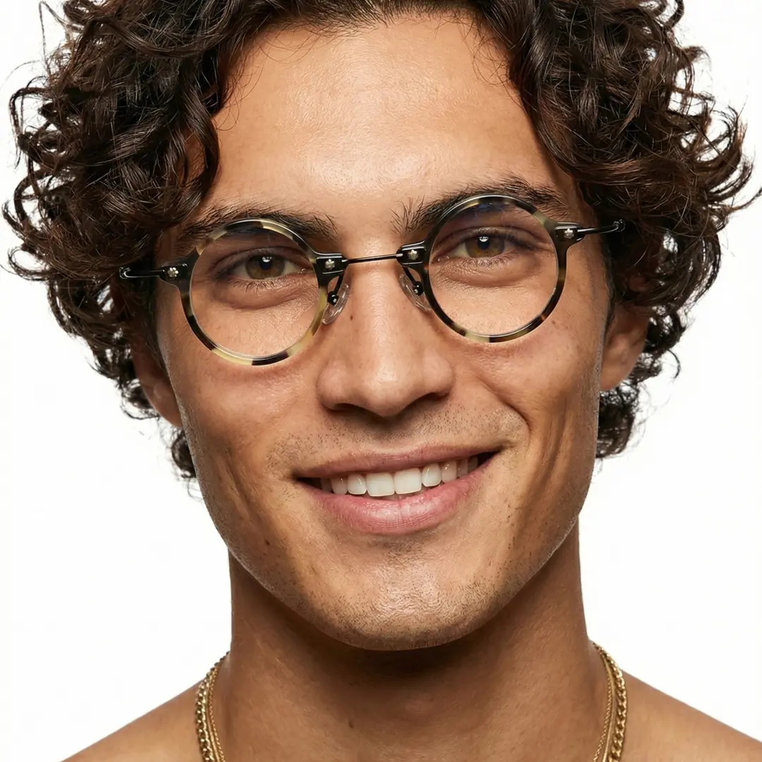 Front view of male wearing steampunk yellow tortoise round eyeglasses, smiling, RA0142402
