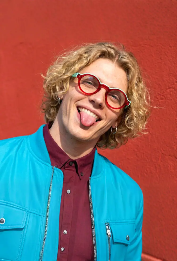 Male model wearing retro colorful red round acetate eyeglasses in outdoor street setting. SPU: RA0152406