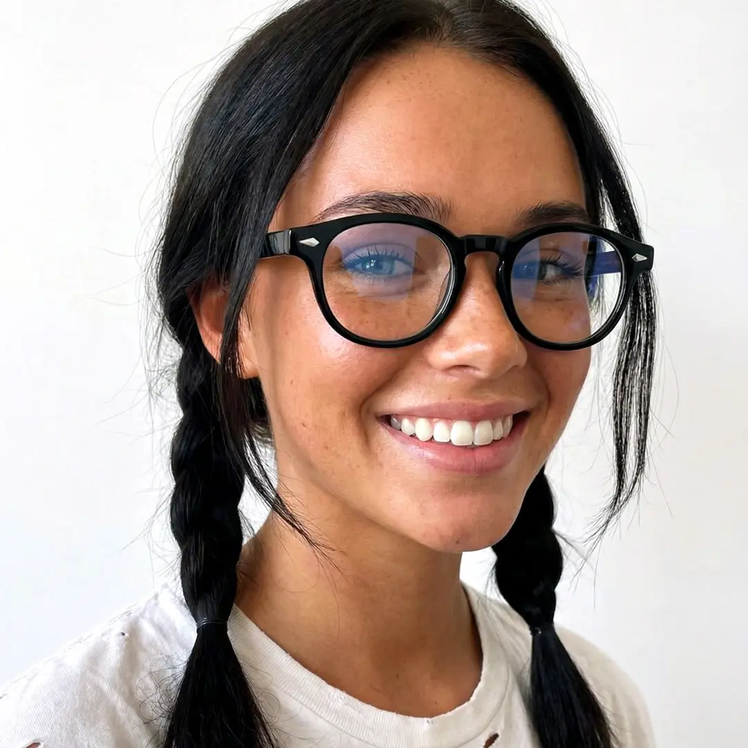 Over-the-shoulder view of female wearing black round eyeglasses, smiling, RA0152411