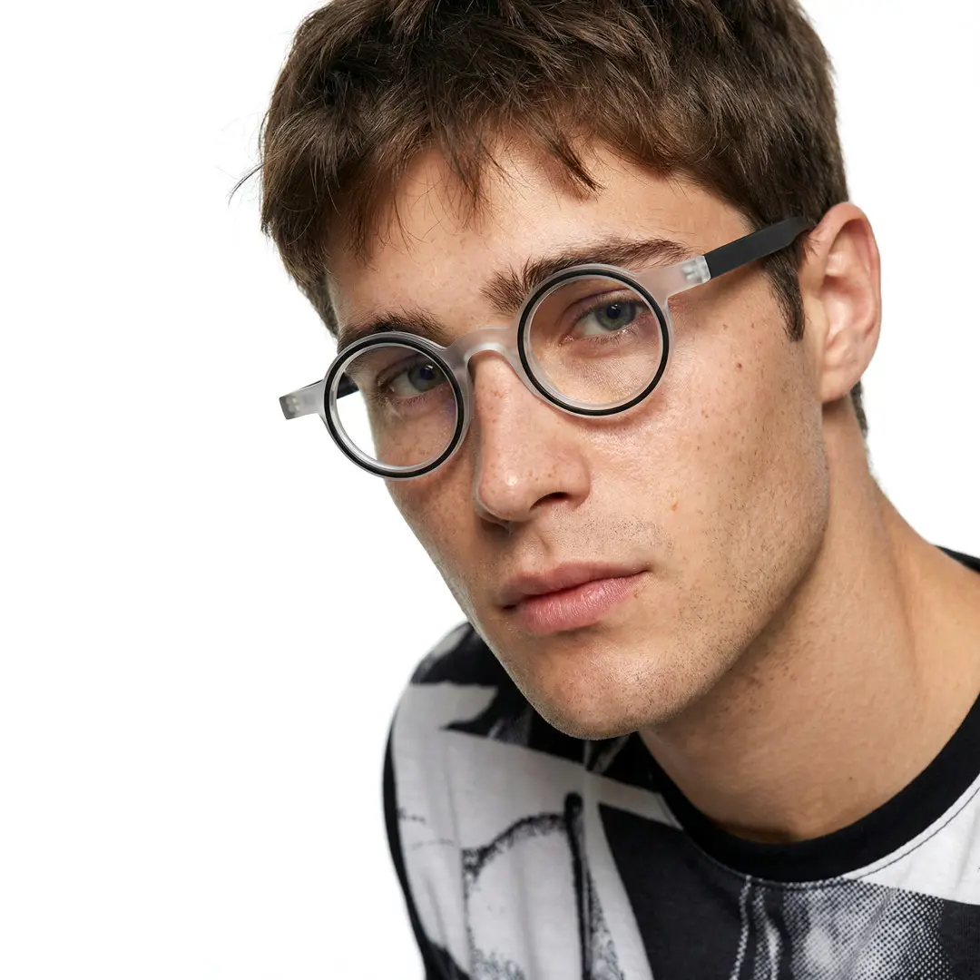 Profile view of male wearing black round eyeglasses, natural expression, RA0162406
