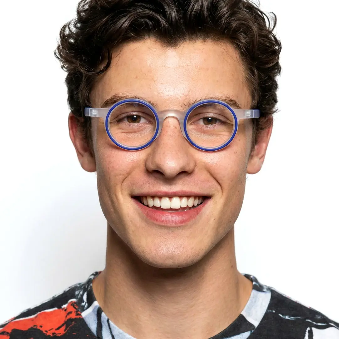 Front view of male wearing blue round eyeglasses, smiling, RA0162406
