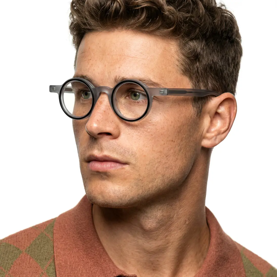 Looking away view of male wearing grey round eyeglasses, neutral expression, RA0162406
