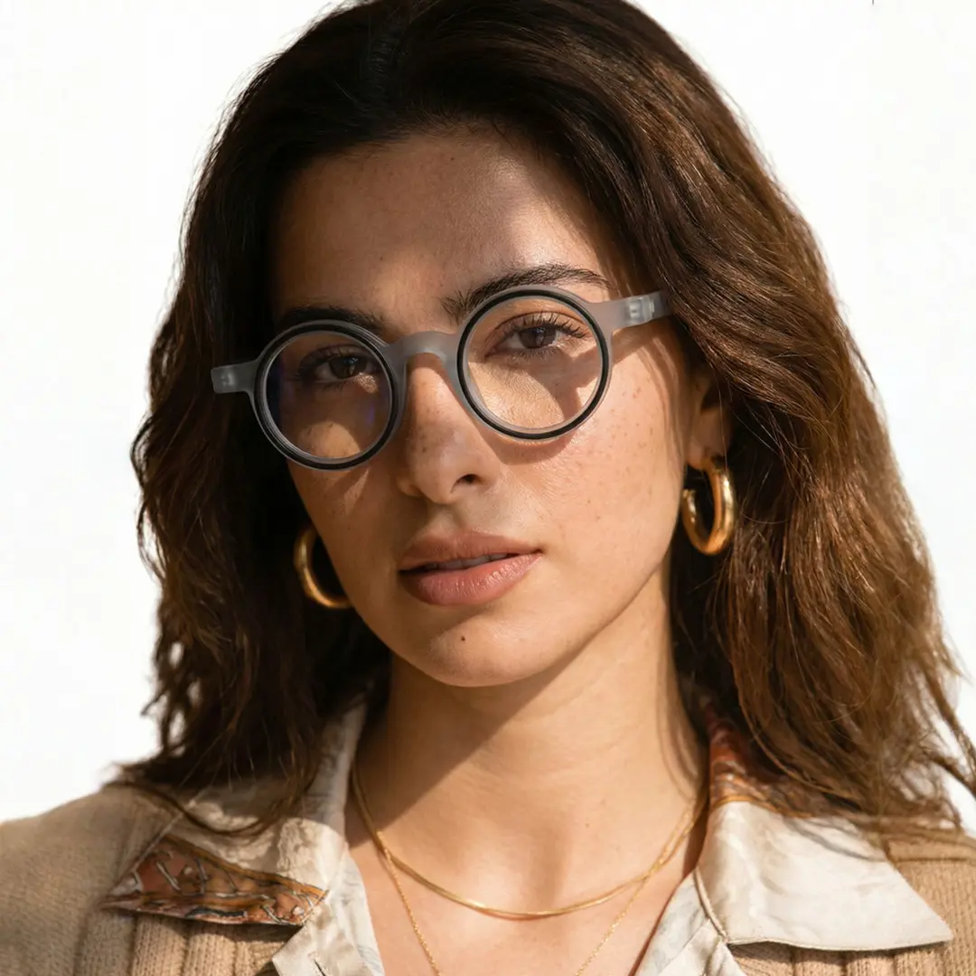 Portrait view of female wearing grey round eyeglasses, natural expression, RA0162406