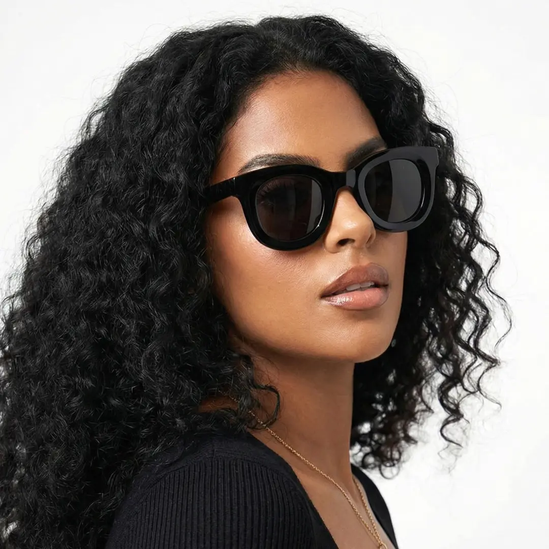 Three-quarter view of female wearing black round eyeglasses, neutral expression, RA0182406