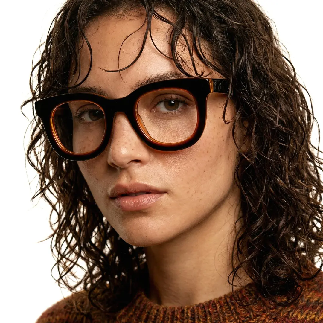 Slightly angled view of female wearing brown round eyeglasses, natural expression, RA0182406