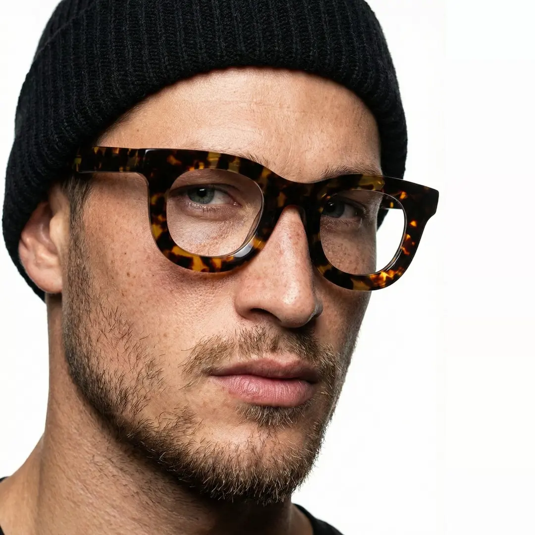 Three-quarter view of male wearing tortoise round eyeglasses, calm expression, RA0182406