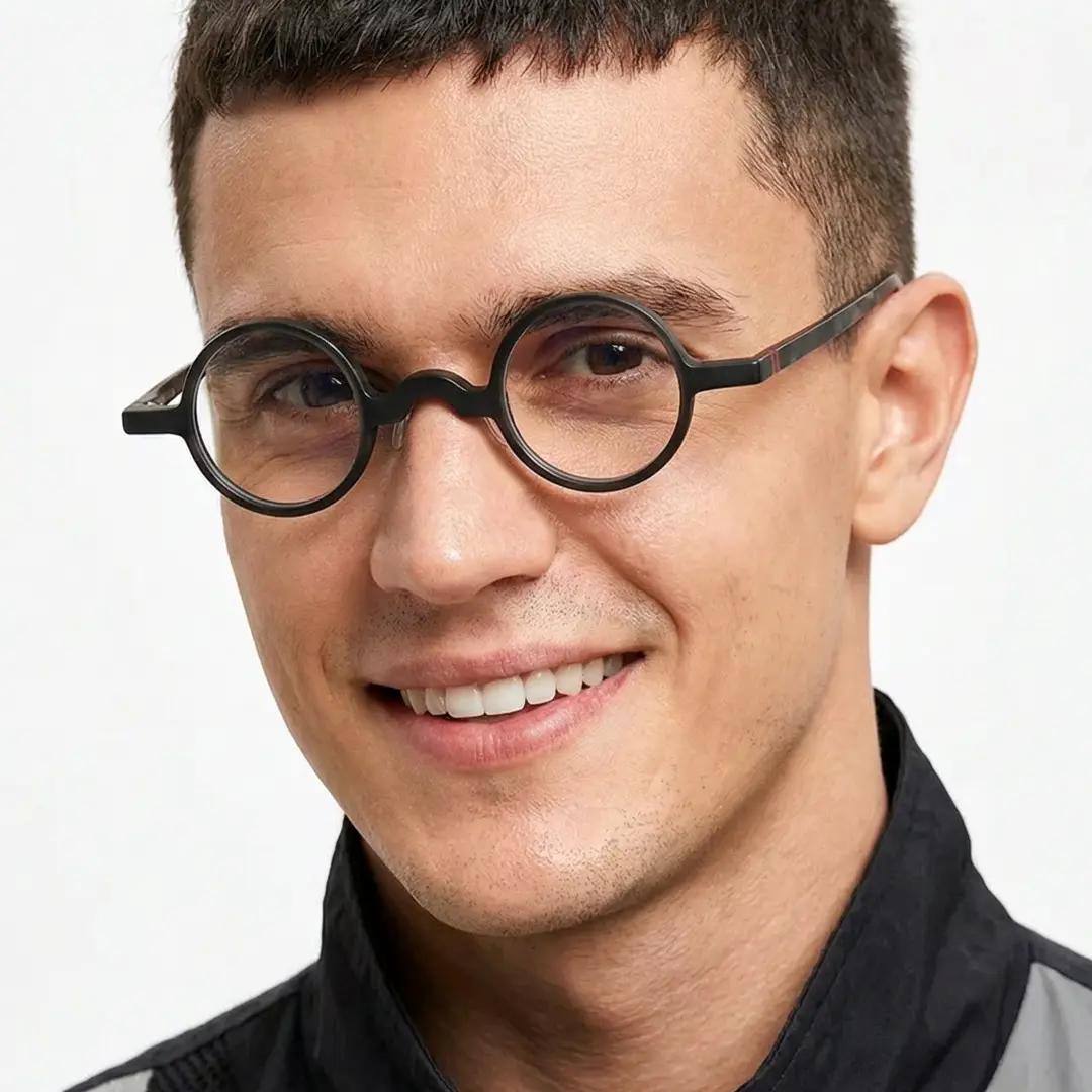 Front view of male wearing vintage black round eyeglasses, friendly smile, RA0202310