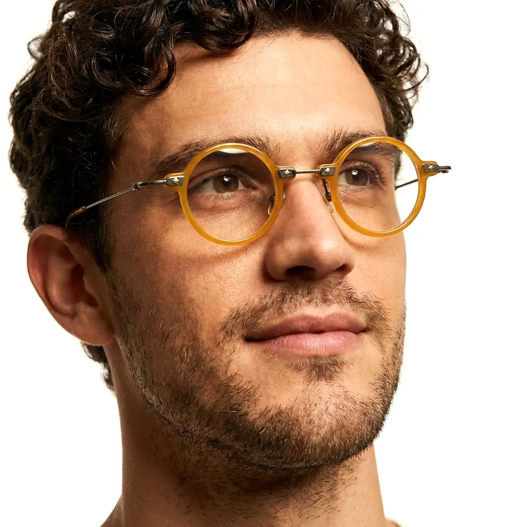 Looking away view of male wearing steampunk yellow round eyeglasses, natural expression, RA0282411