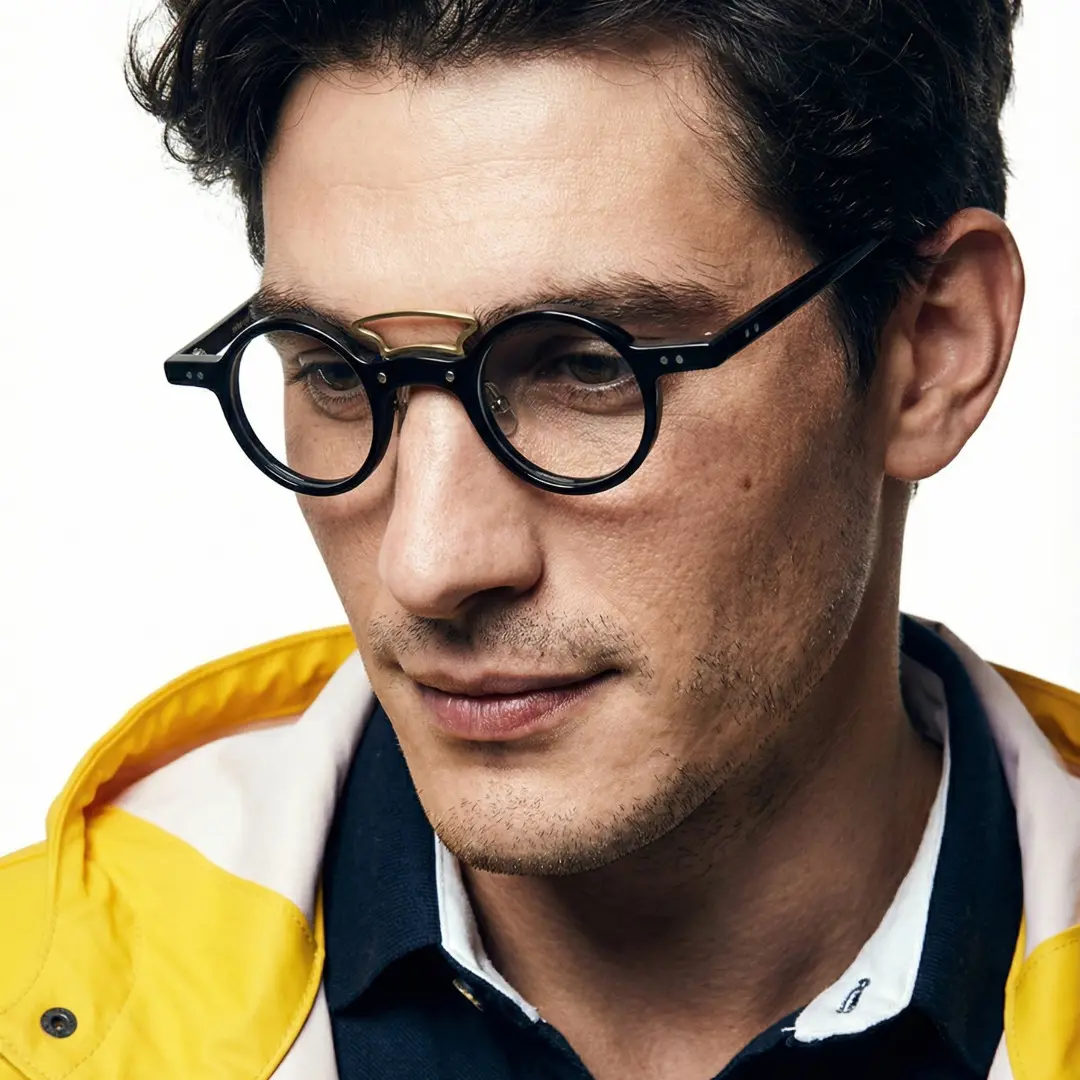 Profile view of male wearing black round eyeglasses, neutral expression, RA0302310