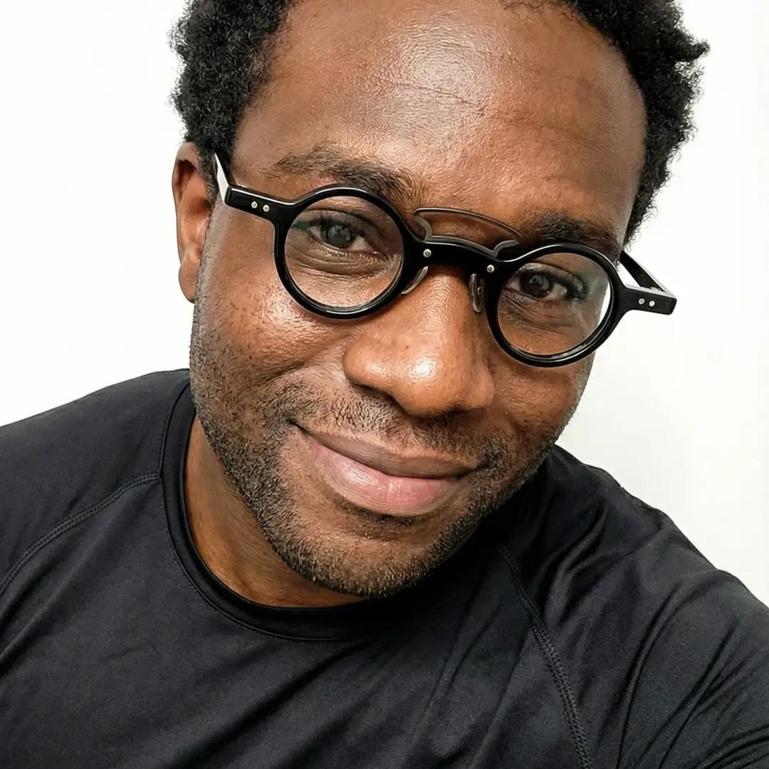 Front view of male wearing vintage black round eyeglasses, natural expression, RA0302310