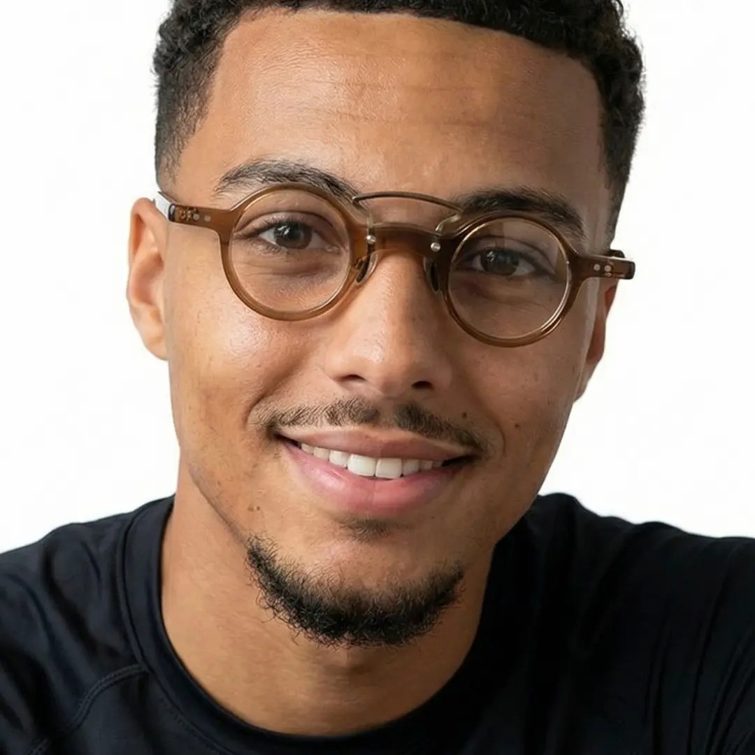 Front view of male wearing brown round eyeglasses, natural smile, RA0302310