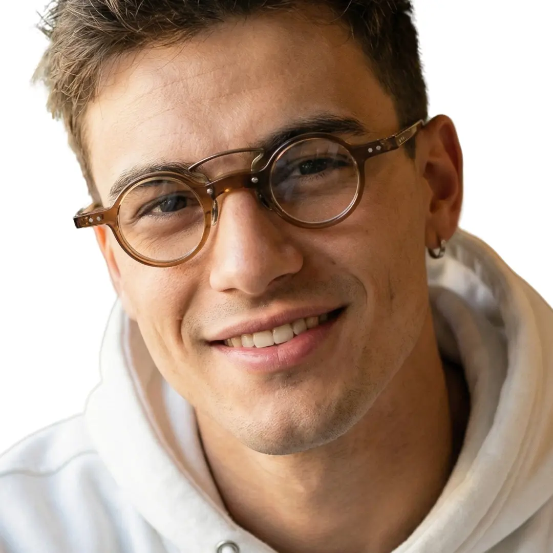 Tilted head view of male wearing brown round eyeglasses, smiling, RA0302310
