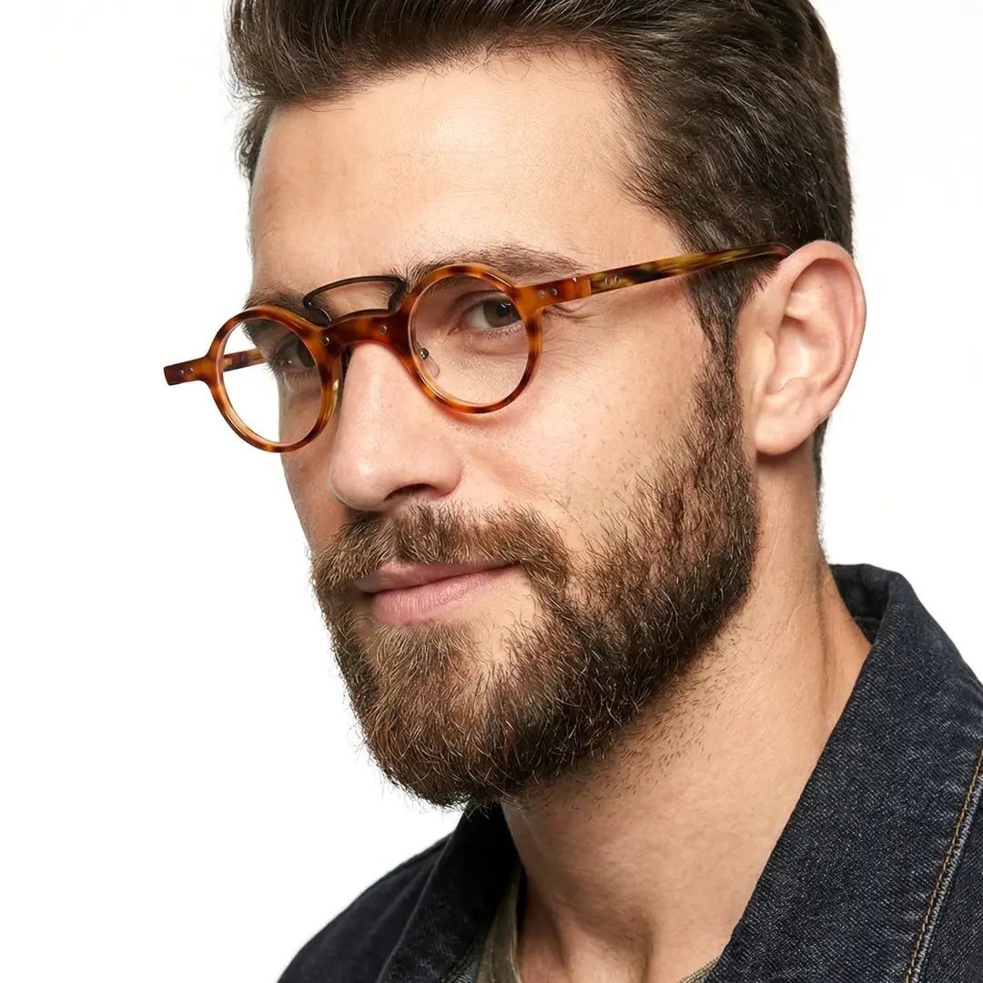 Three-quarter view of male wearing yellowtortoise round eyeglasses, neutral expression, RA0302310
