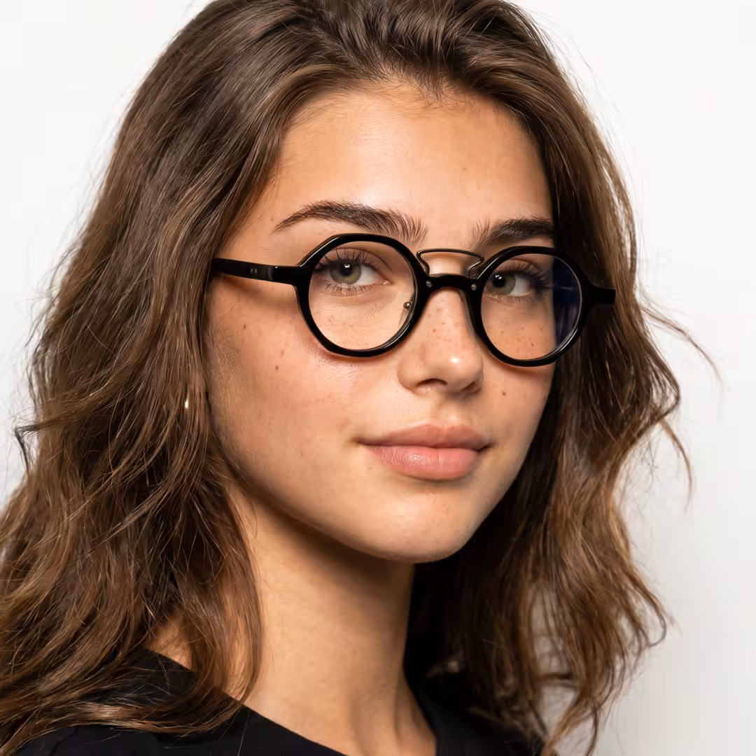 Female wearing vintage black round acetate eyeglasses, giving a subtle smile while looking at camera. SPU: RA0302411