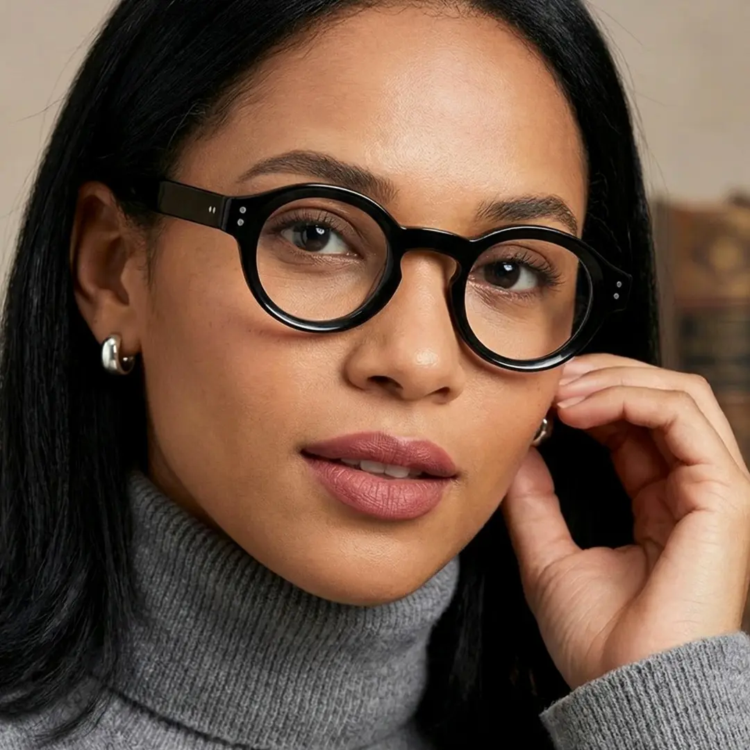 Front view of female wearing vintage black round eyeglasses, hand near face, natural expression, RA0302504