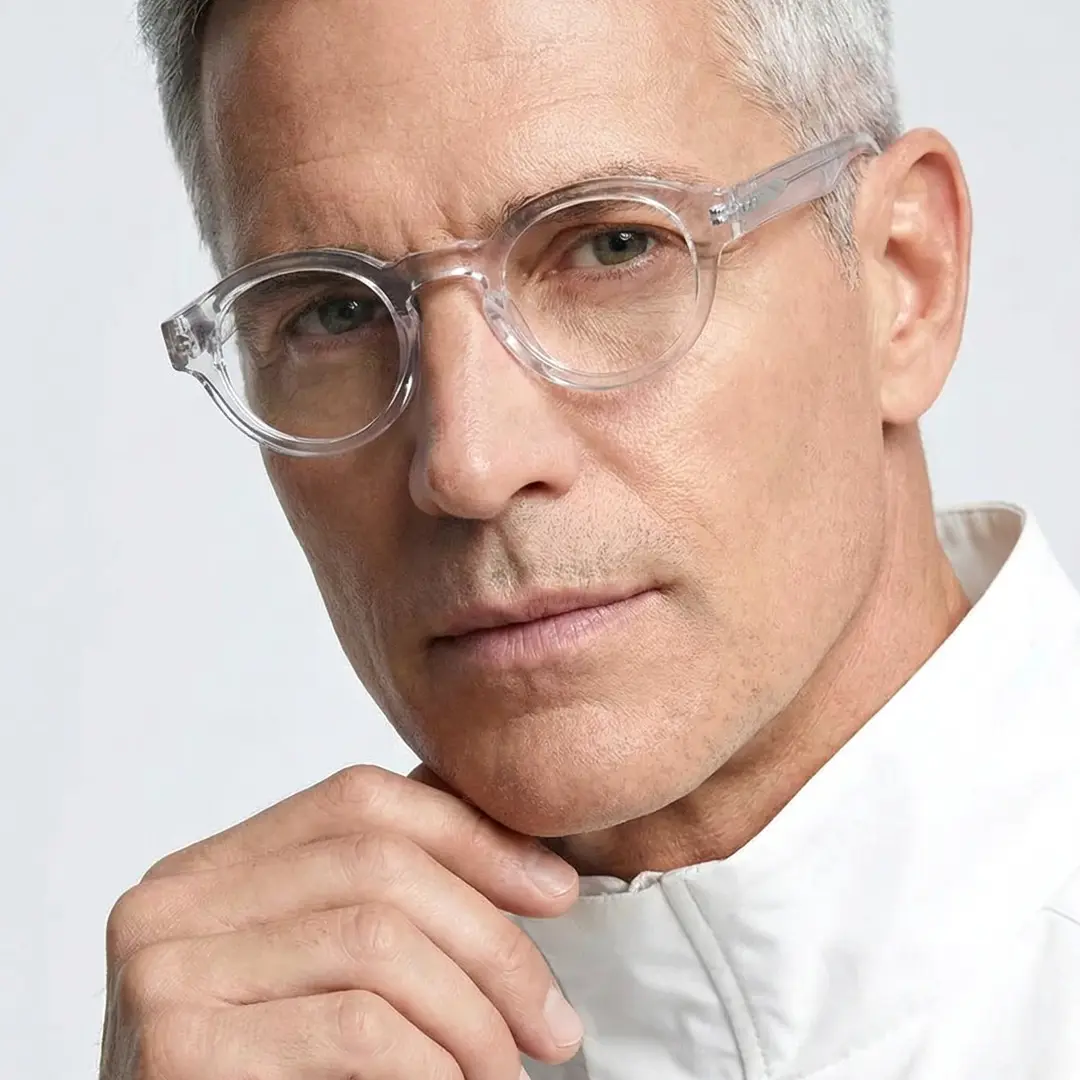 Front view of male wearing vintage clear round eyeglasses, hand near face, natural expression, RA0302504